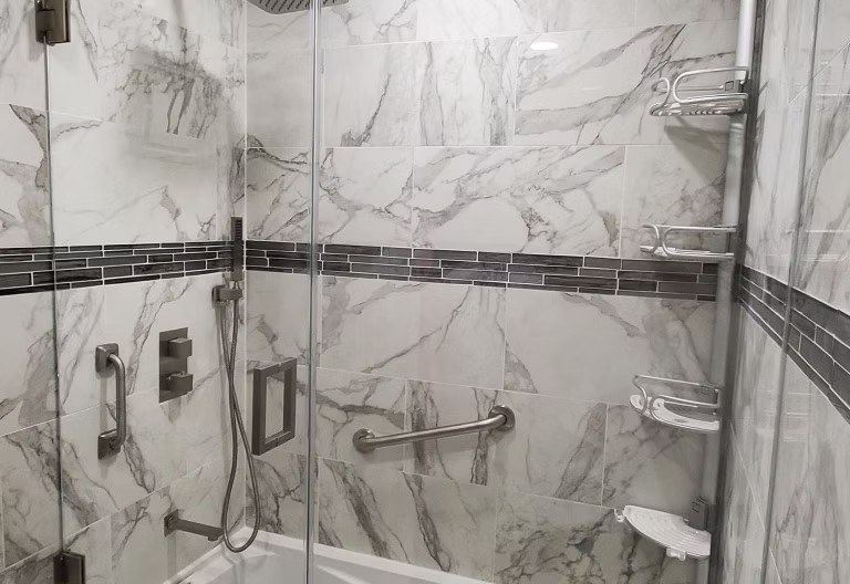 Marble-look tiled shower renovation by La Ferre Contractors